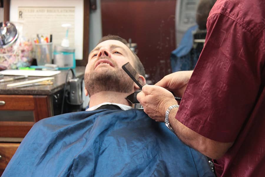 Rafi trimming a man's beard | Scottsdale Barbershop